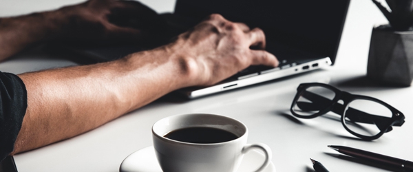 Photo of hands typing on a laptop