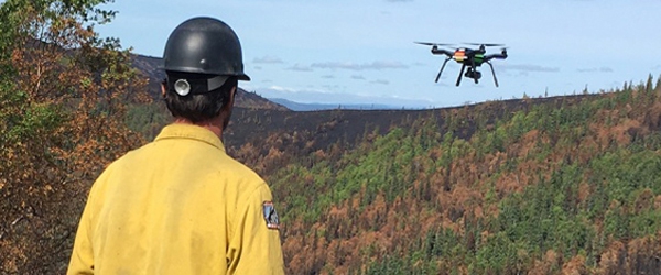 Photo of a man and an Uncrewed Aircraft Systems (UAS)