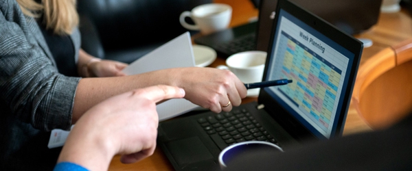 Photo of business people working with laptop