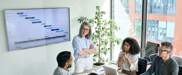 Photo of Diverse corporate team working together in modern meeting room office