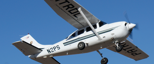 Photo of NPS Patrol plane flying in blue skies