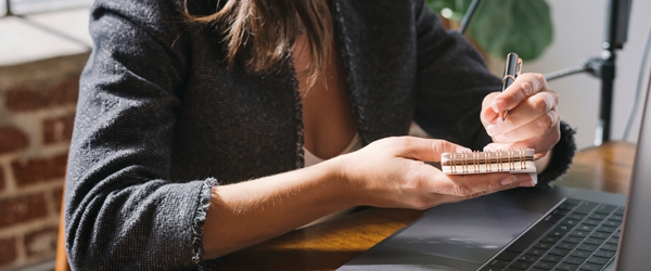 Close up of woman handwriting on a notepad